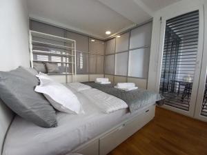 a large bed in a bedroom with a window at Koper's door Apartment in Koper