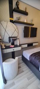 a bedroom with a bed and a chair and shelves at Family Apartment with pool Eden Valley in Alanya +29 photos