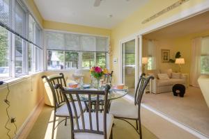 a dining room with a glass table and chairs at Sunny Wells Cottage - 1 Mi to Moody Beach! in Wells