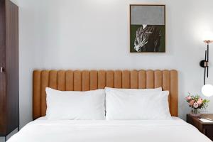 a bedroom with a large bed with white pillows at The Guild Hotel, San Diego, a Tribute Portfolio Hotel in San Diego
