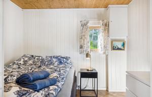 a bedroom with a bed with blue pillows on it at Cozy Home In Sveio With Wifi in Sveio