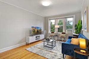 ein Wohnzimmer mit einem blauen Sofa und einem TV in der Unterkunft Spacious & Inviting 1BR Apt in Chicago - Cullom B2 in Chicago