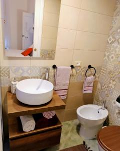 a bathroom with a sink and a toilet at La Casetta Nelle Mura in Terracina