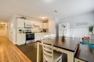 a kitchen with white cabinets and a table and chairs at Walk to Atlantic Beach Family Gem with Fenced Yard in Myrtle Beach