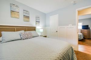 a bedroom with a white bed and a television at Walk to Atlantic Beach Family Gem with Fenced Yard in Myrtle Beach