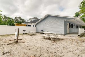 a building with a picnic table in front of it at Walk to Atlantic Beach Family Gem with Fenced Yard in Myrtle Beach
