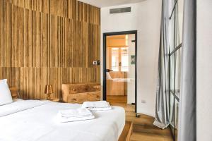 a bedroom with a bed and a bathroom at Luxury Flat by Central Station / Unique View in Milan