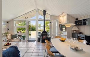 a kitchen and living room with a table and chairs at Beach Front Home In Mesinge With Wifi in Mesinge