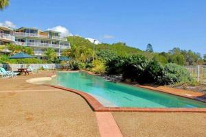 a swimming pool in front of a resort at MarinaView Unit 24 - Break Free Resort- 2 Bedroom Self Contained in Urangan