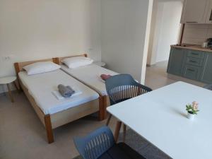 - une chambre avec 2 lits et 2 tables et chaises dans l'établissement Apartments with a parking space Gradac, Makarska - 21437, à Gradac
