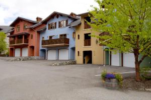 a large apartment building with a parking lot at Snow Creek Village #37 By Bear Country in Sun Peaks +25 photos