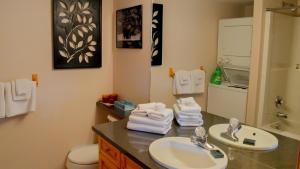a bathroom with a sink and a toilet with towels at Snow Creek Village #49 in Sun Peaks