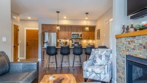 a living room with a bar and a kitchen at Echo Landing #05 by Bear Country in Sun Peaks