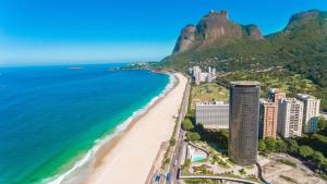 Hotel Nacional Rio de Janeiro في ريو دي جانيرو: اطلالة على شاطئ به مباني و المحيط