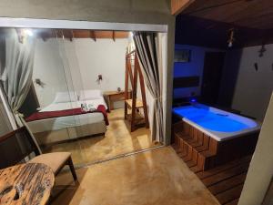 a large bathroom with a tub in a room at Terraço in Guarapari
