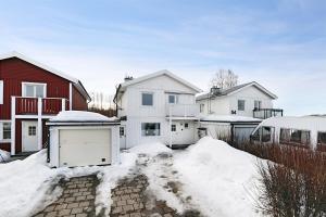 a group of houses in the snow at Guestly Homes - 3BR Seaside Luxury Villa in Piteå