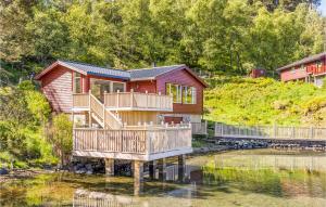 a house with a deck on the water at Cozy Home In Sveio With Wifi in Sveio