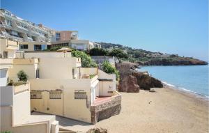 a view of a beach with buildings and the ocean at Awesome Apartment In Sete With Wifi in Sète +7 photos