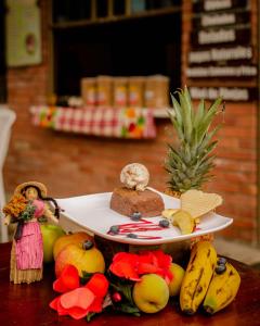 a plate of food sitting on a table with fruit at Villa Libertad in Paipa