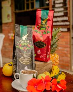 a table with two bags of coffee and a cup of coffee at Villa Libertad in Paipa