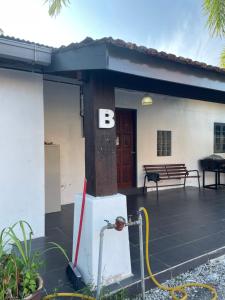 uma casa com um B ao lado em Hj Hassan Guest House Bungalow B em Kuala Terengganu