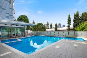 a swimming pool on top of a building at Stadium Vue, 3Bd,Riverview Pool, 300m to S/Stadium in Brisbane