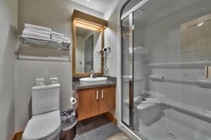 a bathroom with a shower toilet and a sink at Kookaburra Lodge #202 By Bear Country in Sun Peaks