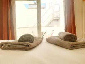 a pair of towels sitting on a table next to a window at Picasso Neighborhood Histórico Y Céntrico in Málaga