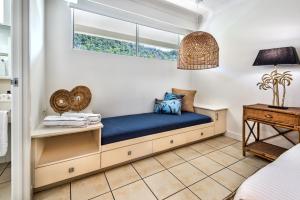 a window seat in a room with a blue couch at Whitsunday Apartments on Hamilton Island by HIHA in Hamilton Island