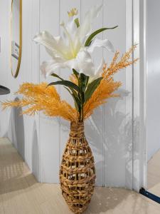 a vase with a white flower in it at VENUS Central Sydney - FEMALE ONLY HOSTEL in Sydney