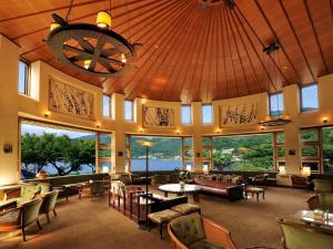 a restaurant with a large room with tables and chairs at Fuji Lake Hotel in Fujikawaguchiko