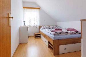 a small bedroom with a bed and a window at Holiday home in Adlesici - Dolenjska & Bela krajina Unter- & Weißkrain 44970 in Adlešiči