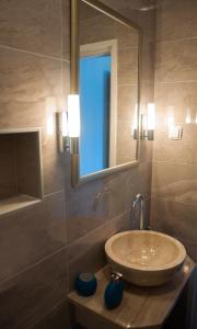a bathroom with a sink and a mirror at Apartment Romano in Korčula