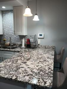 a kitchen with a marble counter top in a room at Nice & Near Downtown Nashville in Nashville