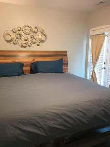 a bedroom with a large bed with blue pillows at Nice & Near Downtown Nashville in Nashville