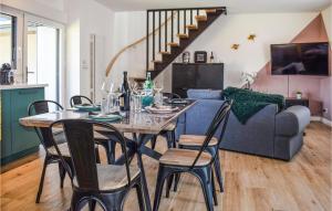 a dining table and chairs in a living room at Amazing Home In Le Vieux-bourg With Private Swimming Pool, Can Be Inside Or Outside in Le Vieux-Bourg