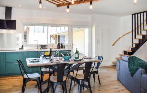 a kitchen and dining room with a table and chairs at Amazing Home In Le Vieux-bourg With Private Swimming Pool, Can Be Inside Or Outside in Le Vieux-Bourg