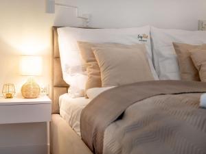 a bedroom with a bed and a table with a lamp at Apartment in Pobierowo near Baltic Sea in Pobierowo