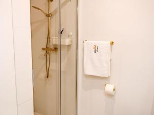 a shower stall with a towel hanging on the wall at Apartment in Pobierowo near Baltic Sea in Pobierowo +21 photos