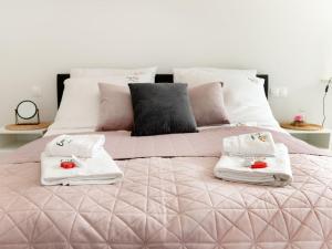 a pink bed with towels on top of it at Modern apartment for 5 people, very close to the beach, Pobierowo in Pobierowo