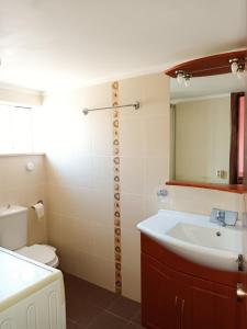a bathroom with a sink and a toilet and a mirror at IRINIS HOUSES in Rhodes Town +20 photos