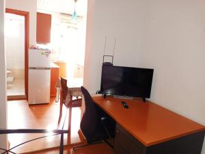 an office with a desk with a television on it at IRINIS HOUSES in Rhodes Town
