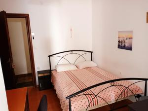 a bedroom with a bed with two pillows on it at IRINIS HOUSES in Rhodes Town