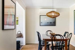 a dining room with a table and chairs at 'The Love Shack' Pet-Friendly Beach Bungalow in Prevelly +28 photos