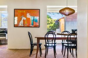 a dining room with a table and chairs at 'The Love Shack' Pet-Friendly Beach Bungalow in Prevelly
