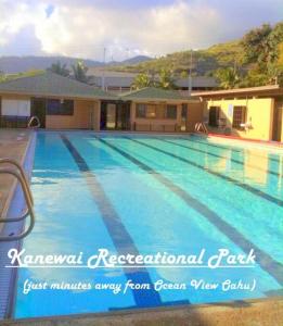 a large swimming pool in front of a house at Mahalo in Honolulu