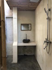 a bathroom with a sink in a room at La Bohème in Gili Islands
