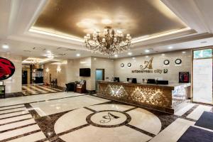 a hotel lobby with a chandelier and a counter at Gangnam Artnouveau City in Seoul