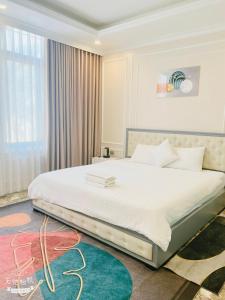 Phúc YênにあるL'ama Villa Đại Lải - Venuestayの窓のある大きな白いベッドのある寝室 +31枚の写真