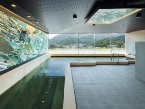 a swimming pool with a large painting on the wall at Hotel Sakura Ureshino in Ureshino